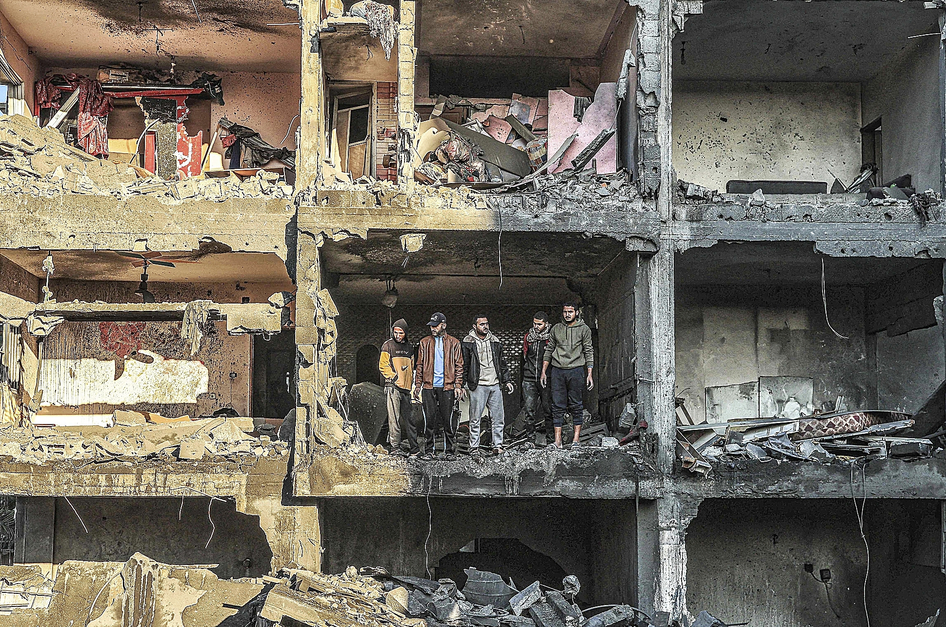Palestinos observan uno de los edificios destruidos tras un bombardeo israelí